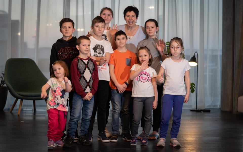 Sally Becker and the Ukrainian orphans she helped get out of Ukraine who are still waiting for confirmation they can come the UK due to last min paperwork delays - Tom Maddick/SWNS- LEEDS