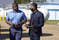 EPA Administrator Michael Regan, right, confers with city engineer Charles Williams at the O.B. Curtis Water Treatment Plant, a Ridgeland based facility near Jackson, Miss., about longstanding water issues that have plagued the city, Monday, Nov. 15, 2021. The visit was one of several stops in a week-long "Journey to Justice" tour through Mississippi, Louisiana, and Texas, spotlighting longstanding environmental concerns in historically marginalized communities. (AP Photo/Rogelio V. Solis)