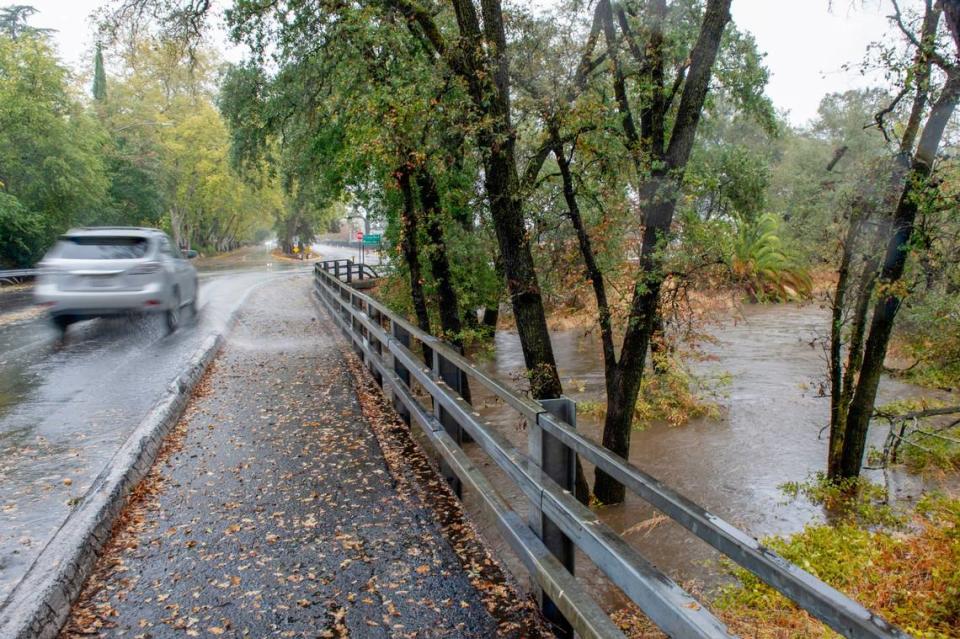 Arcade Creek fills due to the severe rain at the corner of Winding Way and College Oak Drive in Arden Arcade on Sunday, Oct. 24, 2021.