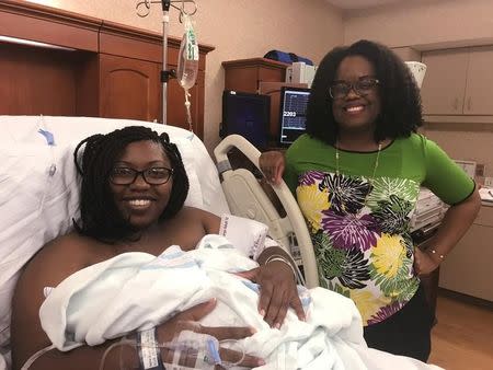 Dr. Nicole Arthur (R), visits Tariyana Wiggins, a high school teacher, shortly after the birth of Troy O’Brien Williams in the hospital room at the North Baldwin Infirmary, a 70-bed hospital in rural Bay Minette, Alabama, U.S. on June 22, 2017. Picture taken on June 22, 2017. REUTERS/Jilian Mincer