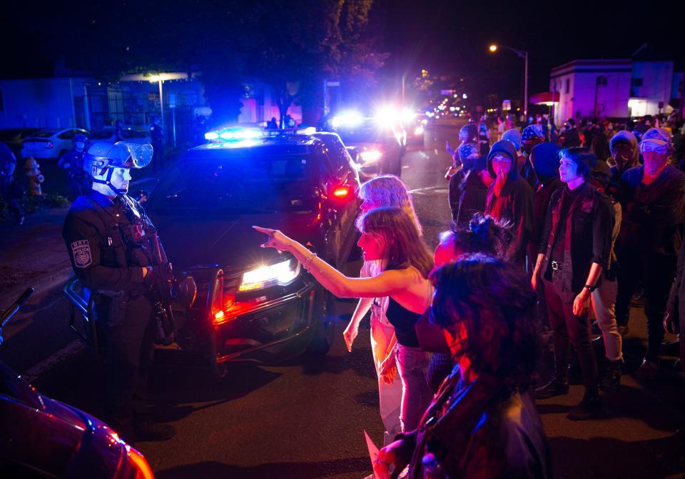 Approximately 100 protesters face-off with Eugene Police deployed in front of Dove Medical during a protest in favor of abortion rights in Eugene Friday June 24, 2022.