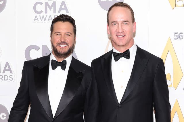 <p>Jason Kempin/Getty </p> Luke Bryan and Peyton Manning at the 2022 CMA Awards