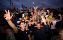 Leeds United fans celebrate outside Elland Road after Huddersfield Town beat West Bromwich Albion to seal their promotion to the Premier League.