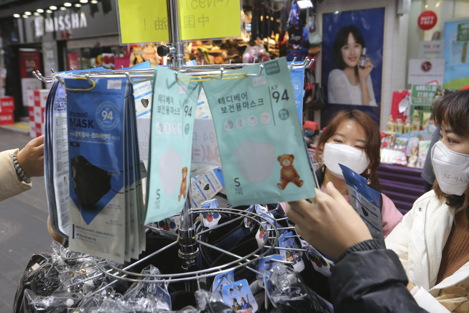 People buy face masks at a shop in Seoul, South Korea, Tuesday, Jan. 28, 2020. Panic and pollution drive the market for protective face masks, so business is booming in Asia, where fear of the virus from China is straining supplies and helping make mask-wearing the new normal. (AP Photo/Ahn Young-joon)