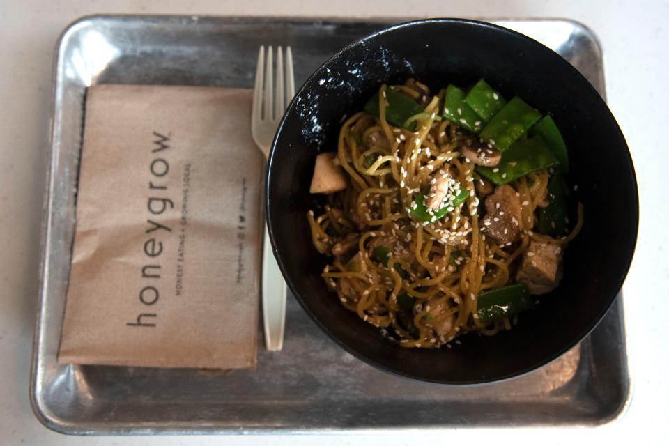 A bowl of sesame garlic stir-fry sits on a table at Honeygrow's new location in Quakertown on Friday, June 3, 2022. This new location is the Philadelphia-based company's 27th since its first store in 2012.