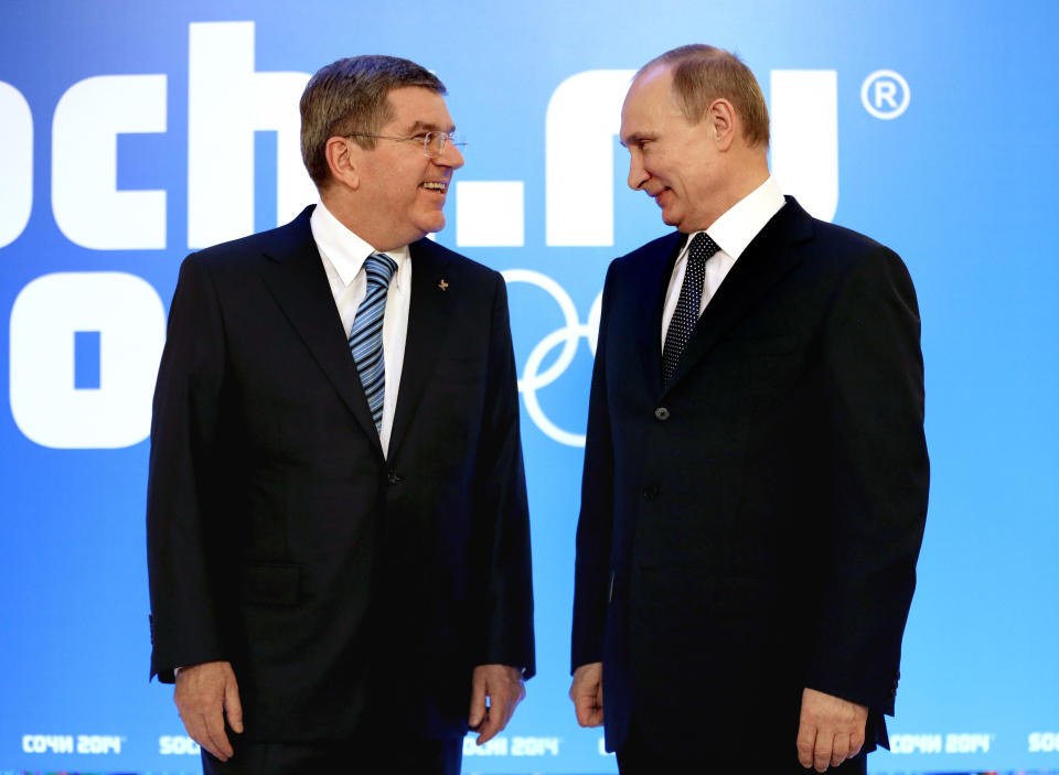 Russian President Vladimir Putin, right, greets International Olympic Committee President Thomas Bach at an event welcoming IOC members ahead of the upcoming 2014 Winter Olympics at the Rus Hotel, Tuesday, Feb. 4, 2014, in Sochi, Russia. (AP Photo/David Goldman, Pool)