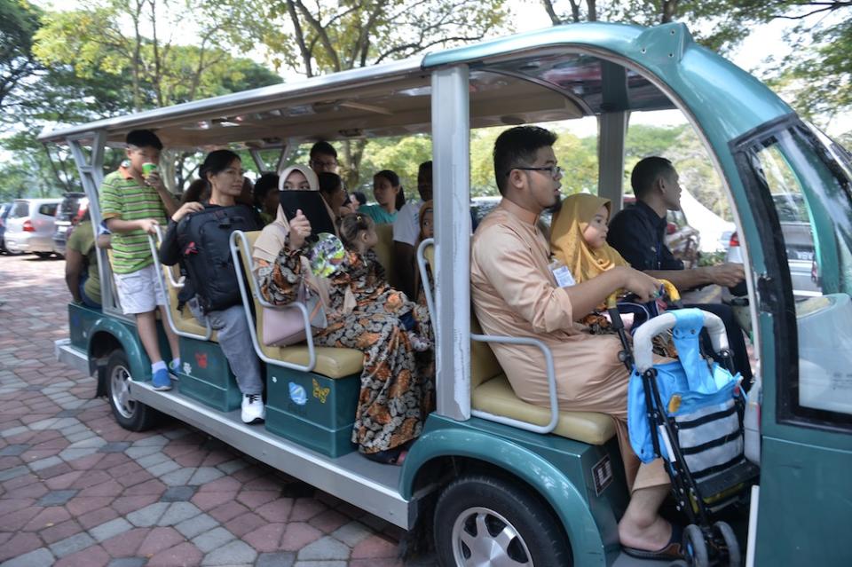 People are ferried in a buggy to the Prime Minister’s Raya Open House at Seri Perdana in Putrajaya June 5, 2019. — Picture by Mukhriz Hazim