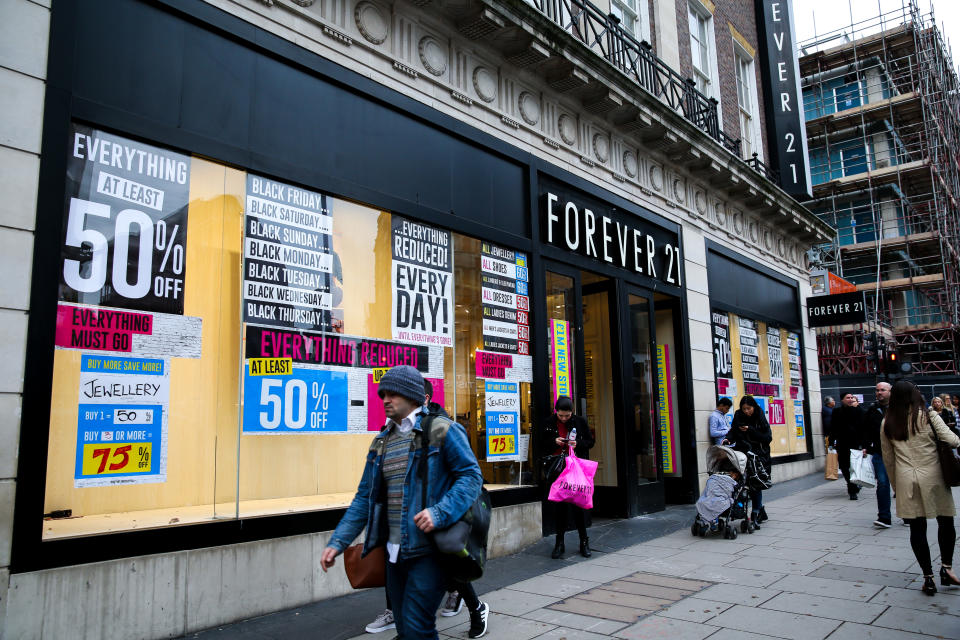 LONDON, UNITED KINGDOM - 2019/11/28: Shoppers walk past the Closing Down signs in the window of Forever 21 store on Oxford Street in London. (Photo by Steve Taylor/SOPA Images/LightRocket via Getty Images)