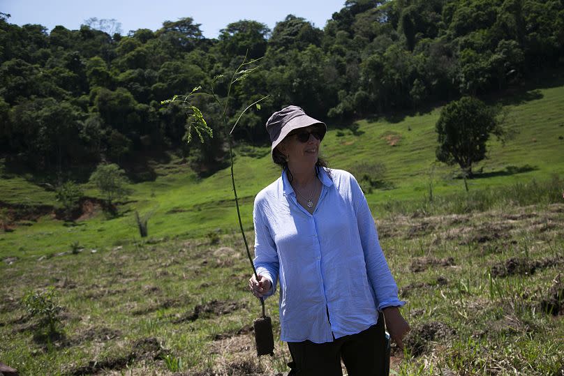 Sarah Darwin, the great-great-granddaughter of Charles Darwin, participates in the planting of tree seedlings.