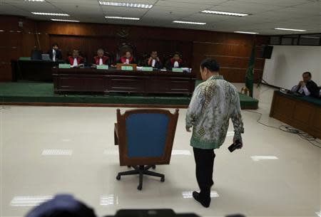 Indonesian police general Djoko Susilo walks to his chair during the delivery of his verdict at a courtroom in Jakarta September 3, 2013. REUTERS/Beawiharta