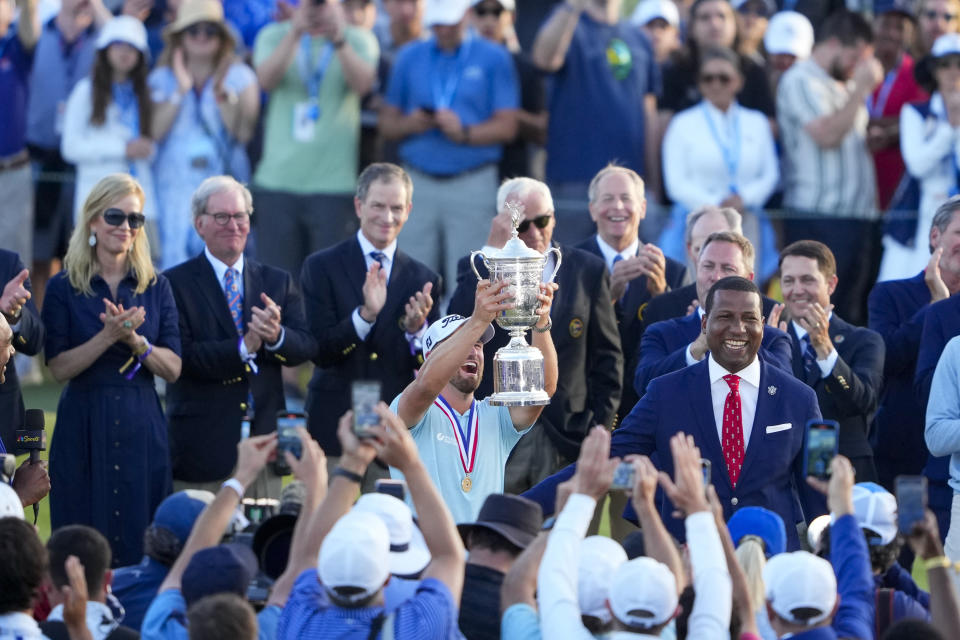 Wyndham Clark celebrates the the trophy on the 18th hole after winning the U.S. Open golf tournament at Los Angeles Country Club on Sunday, June 18, 2023, in Los Angeles. (AP Photo/Lindsey Wasson)