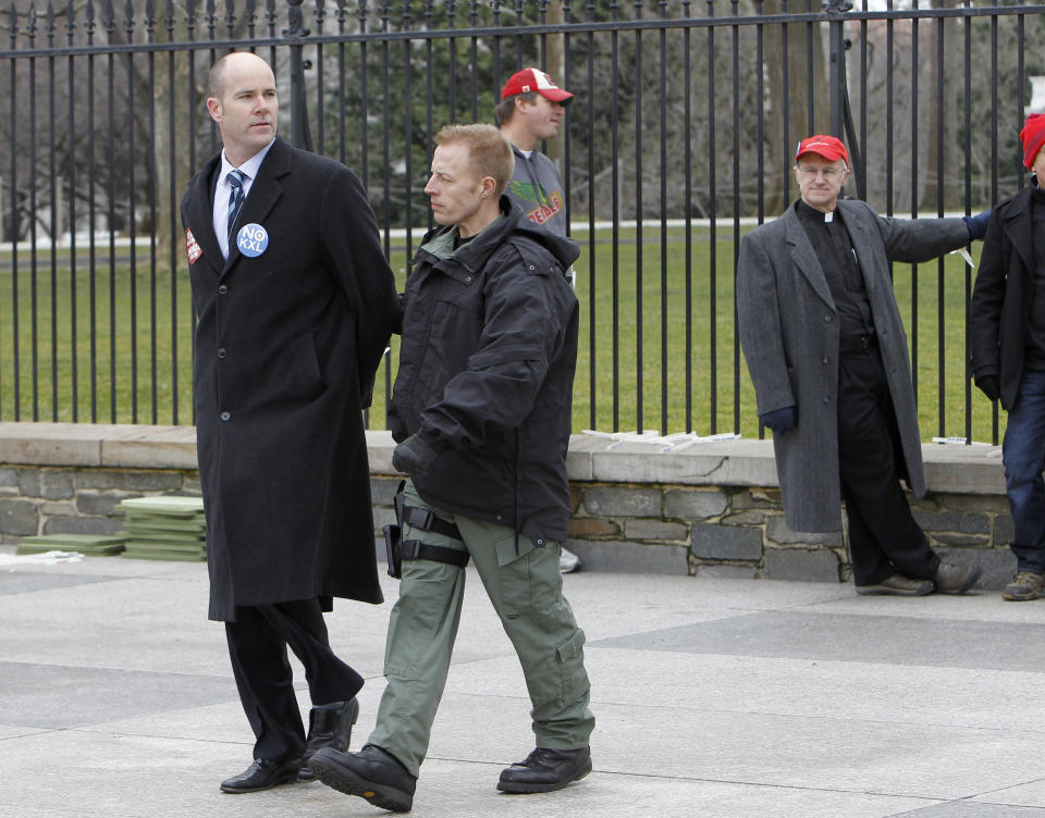 FILE - This Feb. 13, 2013 file photo shows Sierra Club Executive Director Michael Brune being arrested outside the White House in Washington, as prominent environmental leaders tied themselves to the White House gate to protest the Keystone XL oil pipeline. President Barack Obama is sticking to a fossil-fuel dependent energy policy, delivering a blow to a monthslong, behind-the-scenes effort by nearly every major environmental group to convince the White House that the policy is at odds with his goals on global warming. (AP Photo/Ann Heisenfelt, File)