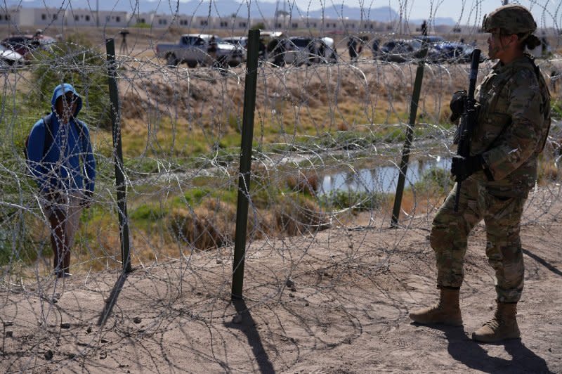 Members of the Operation Lone Star Task Force West and Texas Tactical Border Force block migrants from illegally entering Texas in May near El Paso on the Rio Grande River. File Photo by Mark Otte/UPI