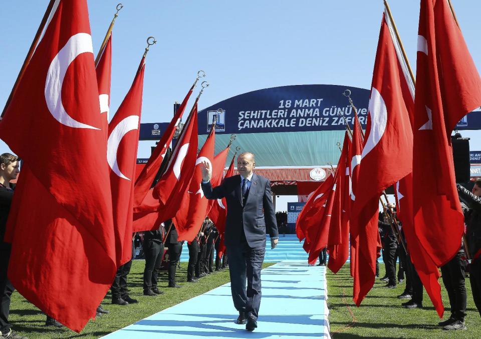 Turkey's President Recep Tayyip Erdogan salutes as he arrives to attend a ceremony marking the 102nd anniversary of Gallipoli campaign, in the Aegean port of Canakkale, near Gallipoli where troops under British command landed in 1915, Saturday, March 18, 2017. Cheered by flag-waving supporters, the Turkish president turned a commemoration of a World War I campaign into a political rally on Saturday, slamming Europe and declaring that a constitutional referendum next month on whether to expand his powers will enhance Turkey's place in the world.(Kayhan Ozer/Presidential Press Service, Pool Photo via AP)