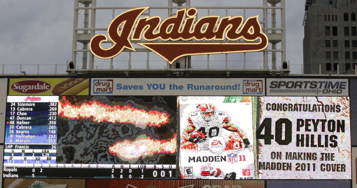 FILE - On the centerfield scoreboard at Progressive Feld during the second inning of a baseball game between the Cleveland Indians and the Kansas City Royals, a message congratulates Cleveland Browns running back Peyton Hillis for winning the fan vote to earn the spot on the cover of the Madden NFL '12 video game, in Cleveland on Wednesday, April 27, 2011. The Indians began removing the team's scripted logo atop the giant scoreboard at Progressive Field on Tuesday, Nov. 2, 2021, as they transition their name to Guardians.(AP Photo/Amy Sancetta, File)