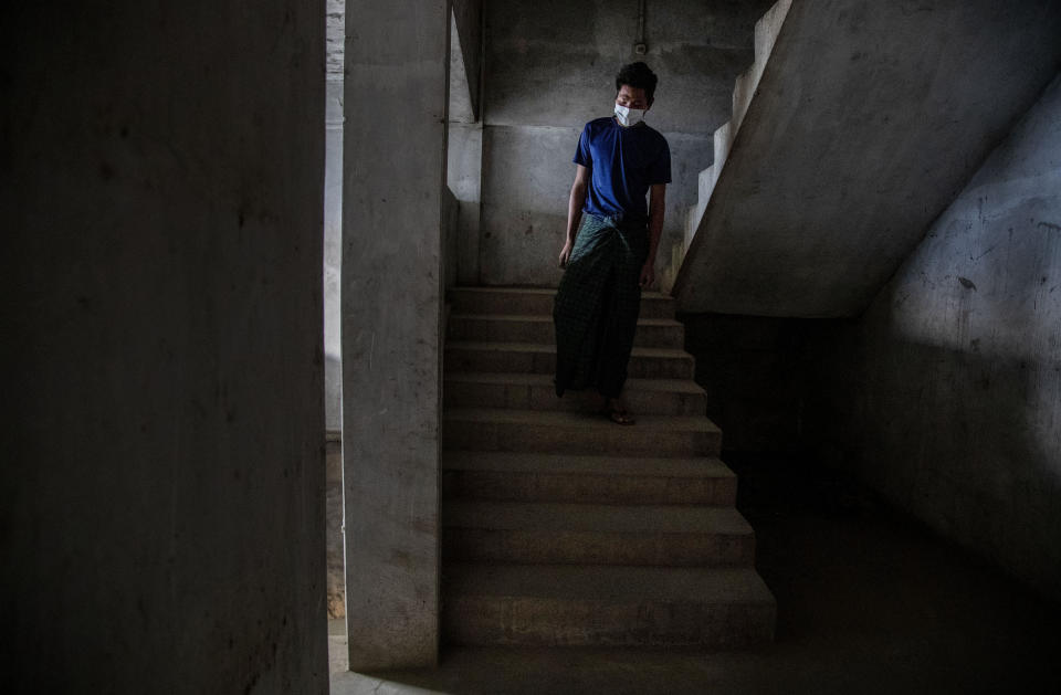 A police officer who fled Myanmar following a military coup walks at an undisclosed location bordering Myanmar, in the northeastern Indian state of Mizoram, Thursday, March 18, 2021. Villagers in Mizoram have given shelter to 34 Myanmar police personnel and 1 fire fighter, who crossed over to the state over the last two weeks. Those who escaped spend their time watching local television and doing daily chores. Some of them have carried mobile phones and are trying to connect to families they were forced to leave behind. At night, all of them go to sleep on mattresses laid on the floor of a single room. (AP Photo/Anupam Nath)