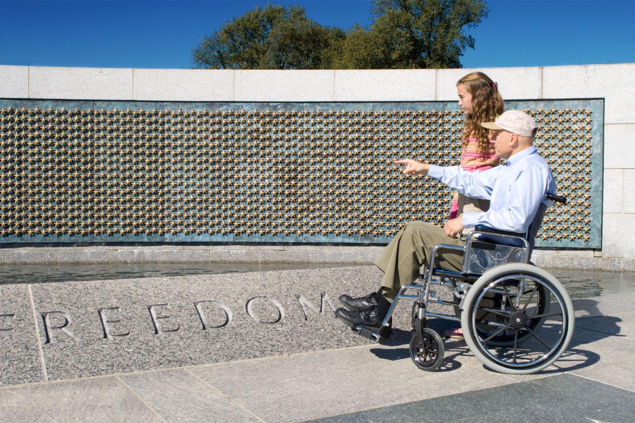 grandfather in wheelchair and granddaughter at World War II Memorial