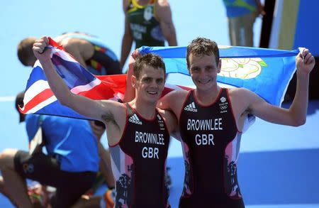 2016 Rio Olympics - Triathlon - Final - Men's Final - Fort Copacabana - Rio de Janeiro, Brazil - 18/08/2016. Alistair Brownlee (GBR) of Britain and Jonathan Brownlee (GBR) of Britain celebrate. REUTERS/Toby Melville