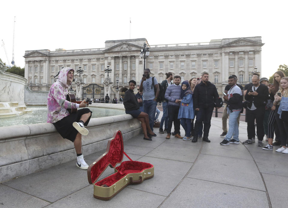 Ese mismo mes el cantante no dudó en coger su guitarra y dedicarle unas canciones a su amor con el palacio de Buckingham como telón de fondo y la sorpresa de los que pasaban por ahí. (Foto: KGC-182 / Star Max / IPx 2 / AP)