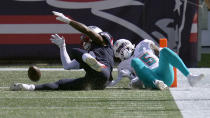 New England Patriots wide receiver N'Keal Harry, left, fumbles the ball at the goal line in front of Miami Dolphins linebacker Jerome Baker, right, in the second half of an NFL football game, Sunday, Sept. 13, 2020, in Foxborough, Mass. The ball rolled out of the end zone for a Dolphins touchback. (AP Photo/Charles Krupa)