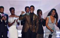 Chadwick Boseman (C) accepts the top SAG Award for "Black Panther" flanked by his castmates including Michael B. Jordan (L), Danai Gurira (C), Lupita Nyong'o (2R) and Angela Bassett (R)