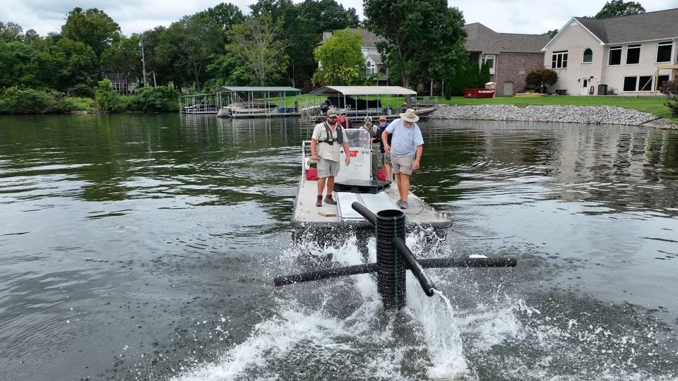 TWRA personnel push an artificial habitat structure down  in deep water on Old Hickory Lake.