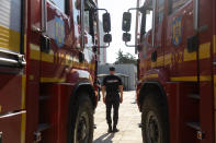 A Romanian firefighter stands in front of a fire engine during a ceremony, in Athens, on Saturday, July 2, 2022. Twenty eight Romanian firefighters, the first of more than 200 firefighters from other European countries that will help their Greek colleagues in fighting wildfires, were welcomed by Climate Crisis and Civil Protection Minister Christos Stylianides and the leadership of Greece's Fire Service. (AP Photo/Yorgos Karahalis)