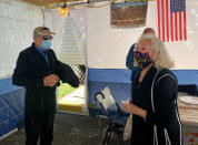 In this photo provided by Larry Brandspiegel, Holocaust survivors Israel "Sasha" Eisenberg, left, and Ruth Brandspiegel are reunited on Oct. 3, 2020, in East Brunswick, N.J. for the first time in more than 70 years since their families left the Hallein Displaced Persons Camp in Austria. They met under a sukkah, a temporary shelter used to celebrate the weeklong Jewish fall holiday of Sukkot. (Larry Brandspiegel via AP)