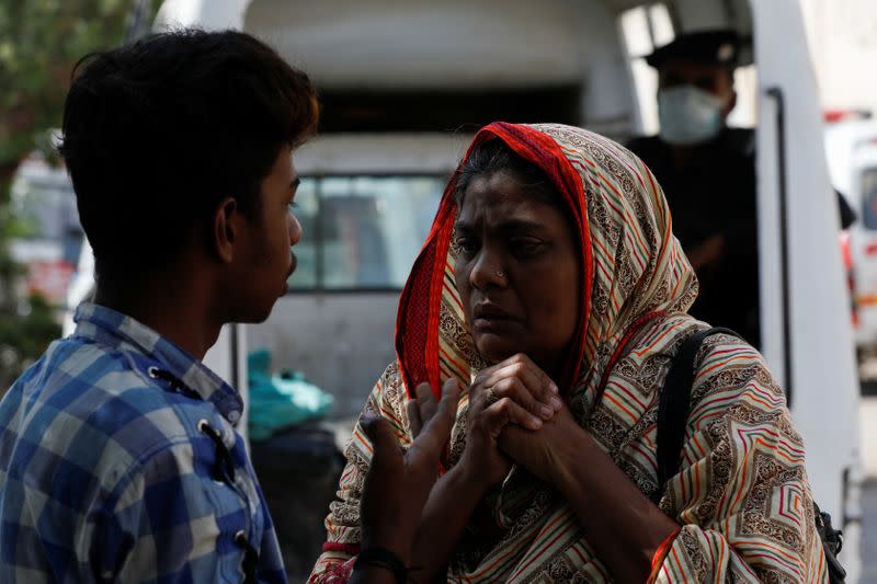 Woman mourns the death of a relative, who was killed in a plane crash, outside a morgue in Karachi