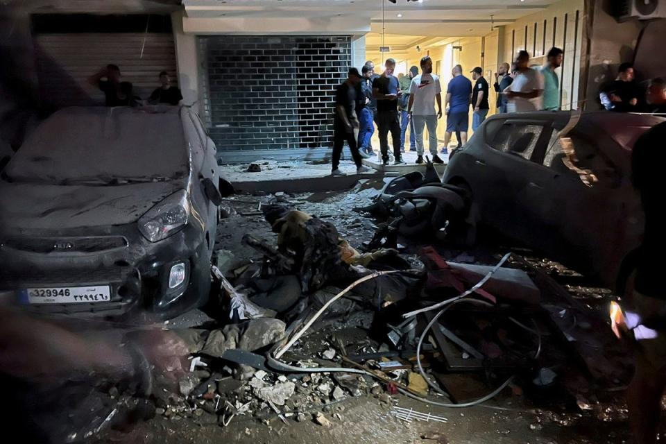 People inspect damaged cars in the southern suburbs of Beirut, Lebanon (Copyright 2024 The Associated Press. All rights reserved)