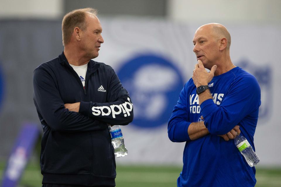 Kansas football coach Lance Leipold (left) talks with recent hire Sean Snyder (right) during the Jayhawks' pro day this year.