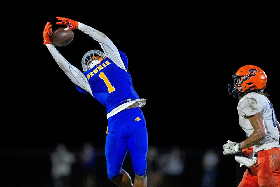 Cardinal Newman cornerback Kevin Levy intercepts the ball against Benjamin during their regional semifinal playoff football game in West Palm Beach on November 17, 2023.