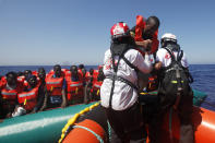 African migrants on a rubber boat in the Mediterranean Sea, off Libya are rescued by the MV Geo Barents vessel of MSF (Doctors Without Borders), in the central Mediterranean route, Monday, Sept. 20, 2021. (AP Photo/Ahmed Hatem)