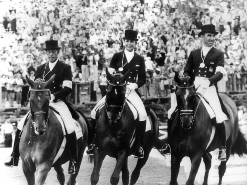 After the award ceremony during the Summer Olympics in Montreal on July 31, 1976, the German team dressage riders Harry Boldt (l) on "Woycek", Gabriela Grillo on "Ultimo" and Dr. Reiner Klimke (r) on "Mehmed" ride through the arena with their gold medals. Dressage Olympic champion Gabriela Grillo has died at the age of 71, the GRILLO-Werke family business said on 27 February evening. -/dpa