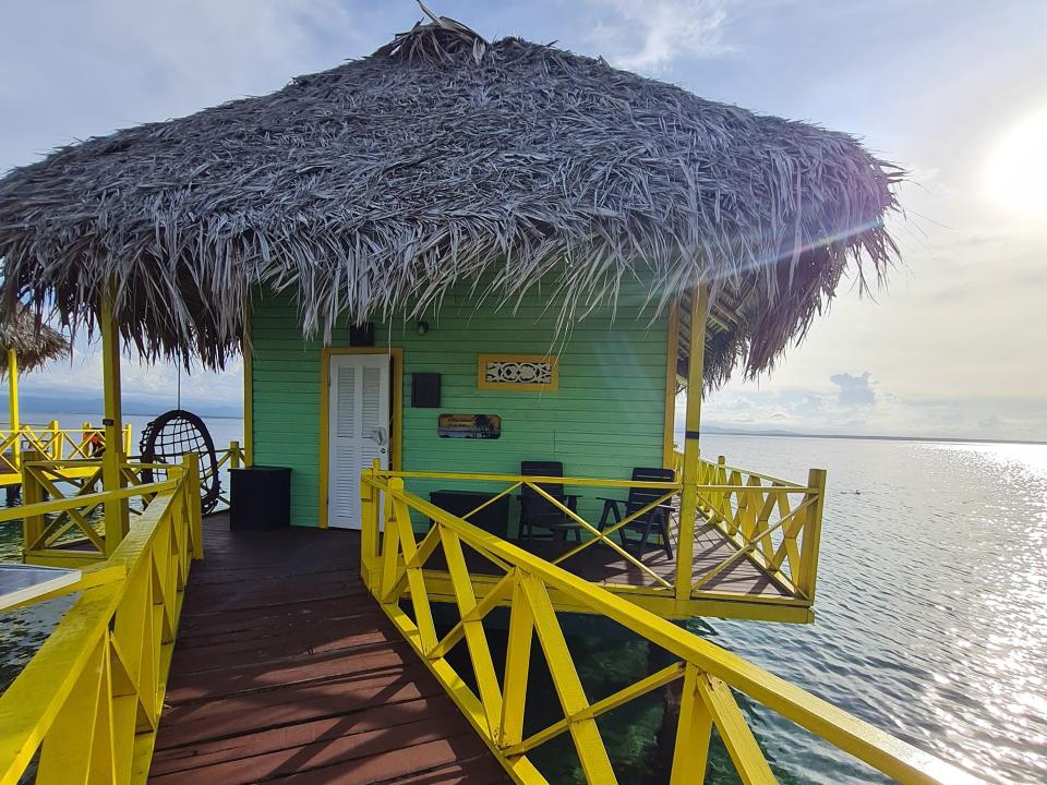 brightly colored bungalow over the ocean in panama