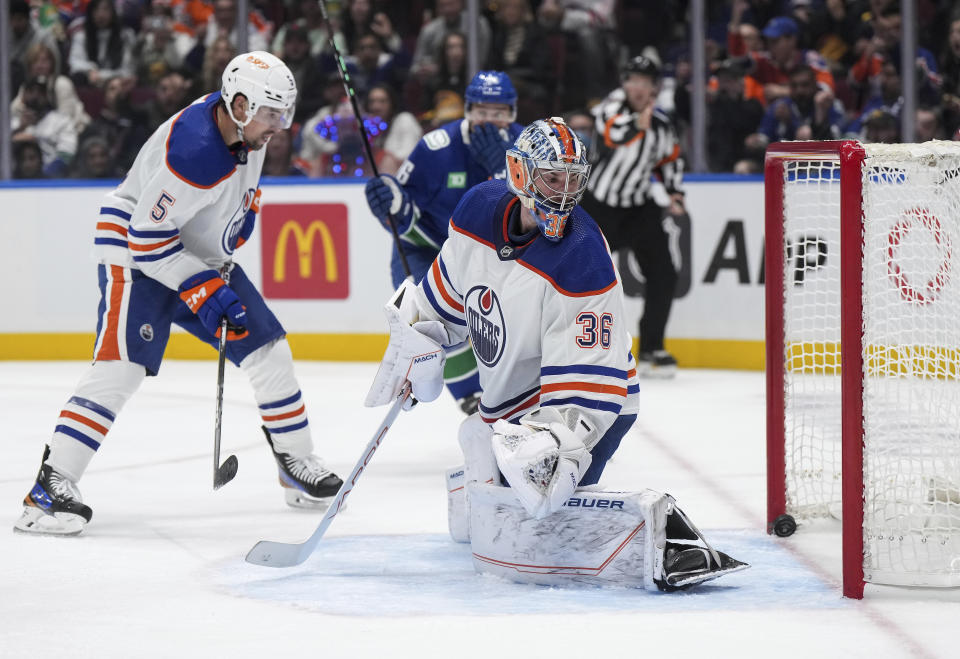 Edmonton Oilers goalie Jack Campbell (36) and Cody Ceci (5) look back at the puck in the net after Vancouver Canucks' Brock Boeser scored during the second period of an NHL hockey game Wednesday, Oct. 11, 2023, in Vancouver, British Columbia. (Darryl Dyck/The Canadian Press via AP)