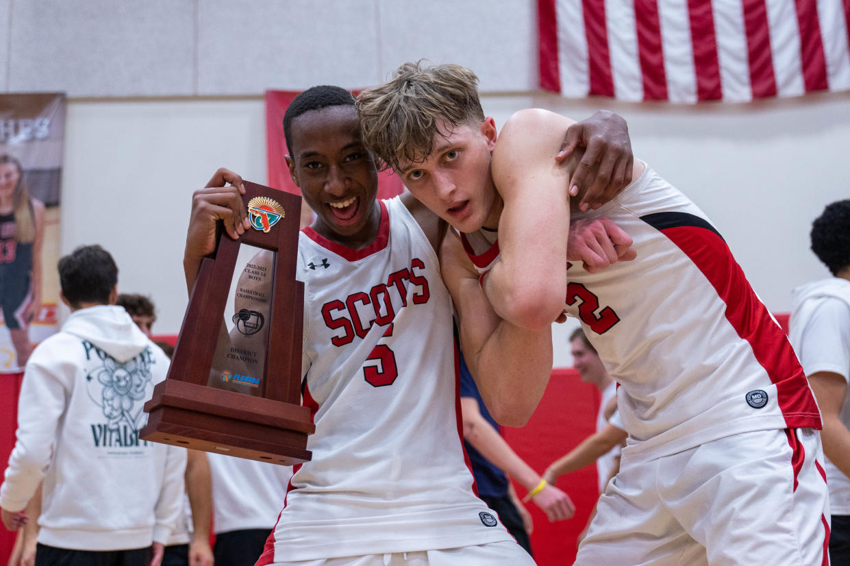 St. Andrew's guard Brooklyn Vick (5) and forward Andrew Sineway (2) celebrate victory at the end of the 3A District 13 boy's basketball championship game between the host Scots and St. John Paul on Feb.10 in Boca Raton. Final score, St. Andrew's, 80, St. John Paul II, 63.