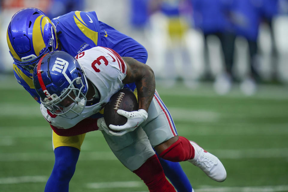 Los Angeles Rams' Jalen Ramsey, top, tackles New York Giants' Sterling Shepard during the first half of an NFL football game, Sunday, Oct. 17, 2021, in East Rutherford, N.J. (AP Photo/Frank Franklin II)