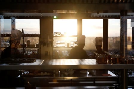 Cooks work at the kitchen of the Marais restaurant in Antananarivo