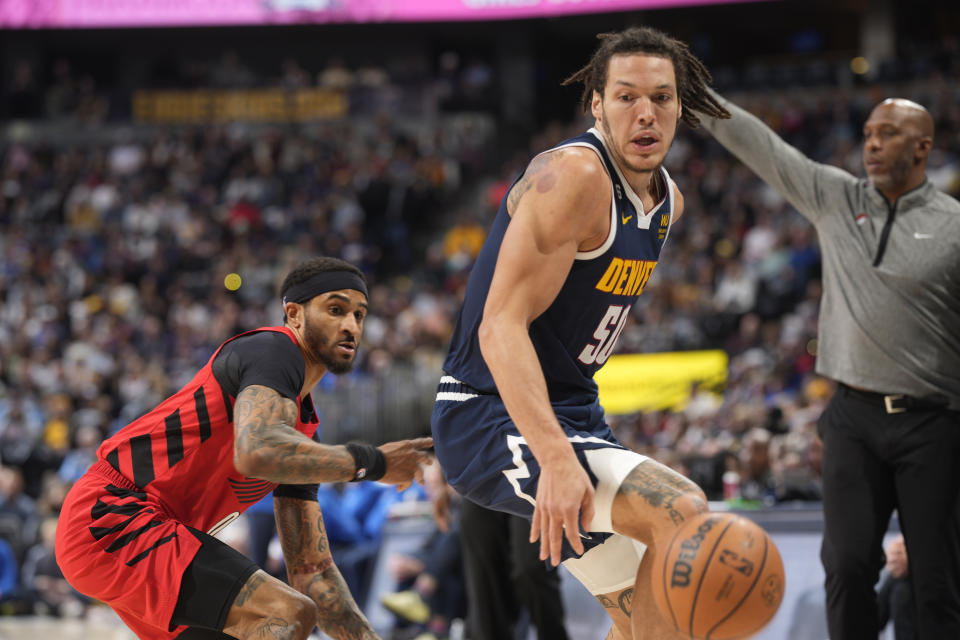 Denver Nuggets forward Aaron Gordon, right, and Portland Trail Blazers guard Gary Payton II watch the ball get away during the second half of an NBA basketball game Tuesday, Jan. 17, 2023, in Denver. (AP Photo/David Zalubowski)