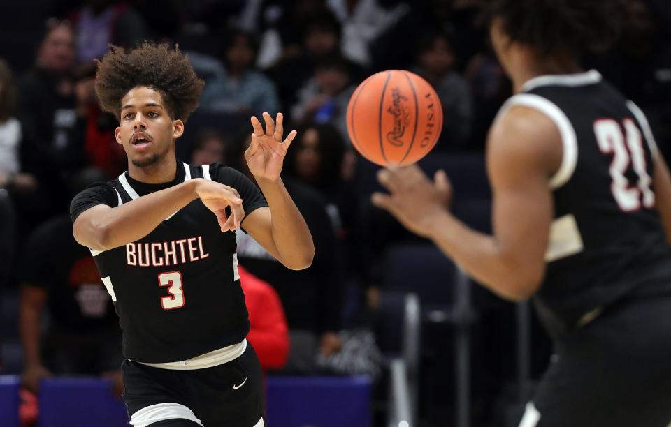 Buchtel guard Amire Robinson, left, makes a pass to guard Khoi Thurmon during the first half of the OHSAA Division II state championship basketball game against Lutheran West at UD Arena, Sunday, March 19, 2023, in Dayton, Ohio.