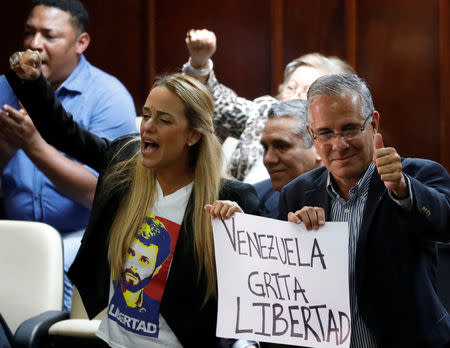 Lilian Tintori, wife of opposition leader Leopoldo Lopez, and Juan Requesens, Deputy Juan Requesens' father, gesture during a National Assembly session in Caracas, Venezuela January 15, 2019. A banner reads: "Venezuela shouts freedom". REUTERS/Manaure Quintero