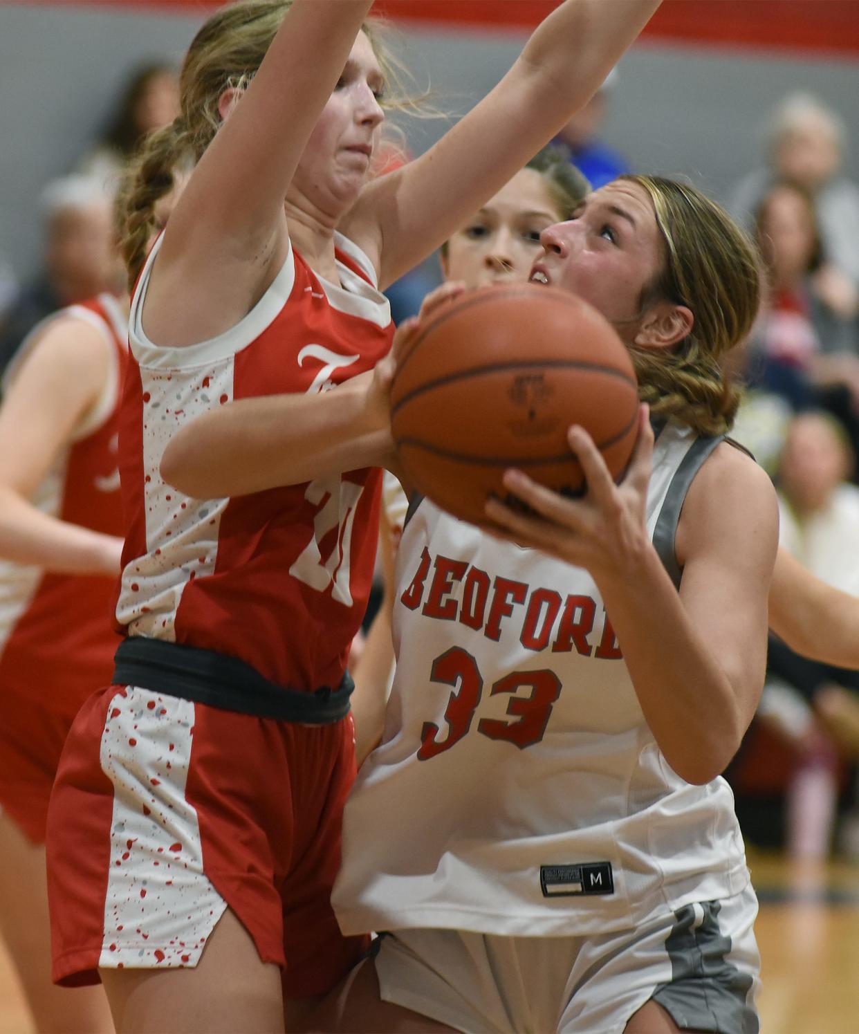 Victoria Gray of Bedford looks for a shot against Monroe's Zoe Leach. Bedford won 55-33 in the semifinals of the Division 1 District at Bedford on Wednesday, March 6, 2024.