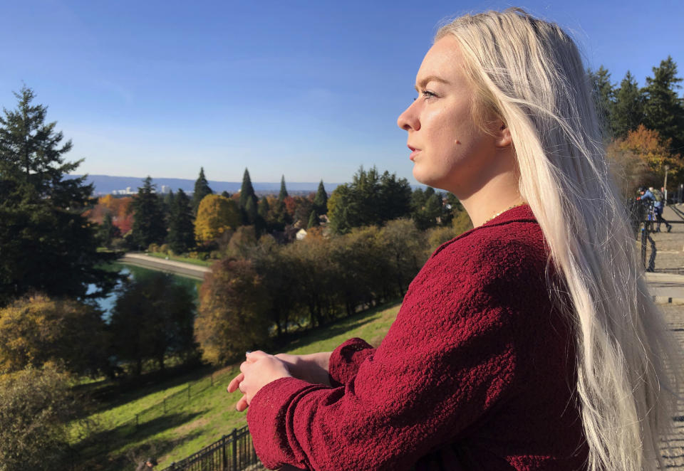 In this Oct. 28, 2019, photo, Ashtyn Aure poses for a photo in Portland, Ore. When Aure visited a clinic at Utah Valley University last year, she felt like she was having a breakdown. When she asked to see a counselor, a staff member told her the wait list stretched for months. She left without getting help. (AP Photo/Gillian Flaccus)