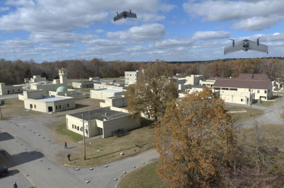 In this photo from the Defense Advanced Research Projects Agency, drones fly in a Defense Department urban warfare exercise at Fort Campbell, Tenn., in Nov., 2021. A single operator supervised a swarm of more than 100 cheap, unscrewed air and land drones at the exercise. With tensions high over Taiwan, U.S. and Chinese military planners are readying themselves for a new kind of war where battleships, fighter jets and amphibious landings cede prevalence to squadrons of AI-enabled air and sea drones. (DARPA via AP)