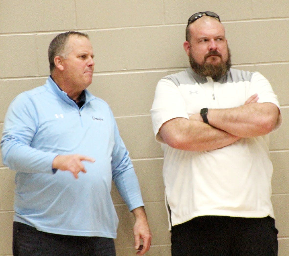 Bartlesville High Athletic Director Thad Dilbeck, left, and new head football coach Harry Wright watch basketball action last January in the Bruin Fieldhouse shortly after Wright was hired.