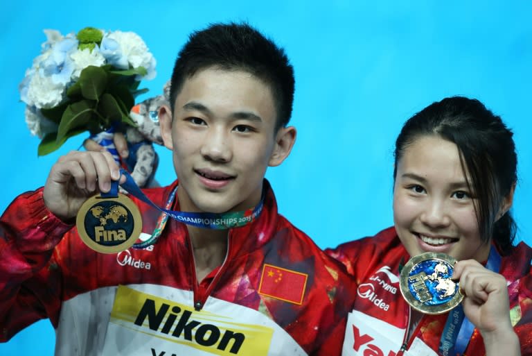 China's divers Wang Han and Yang Hao pose with their gold medals during the podium ceremony of the mixed 3m synchronised springboard final diving event at the 2015 FINA World Championships in Kazan on August 2, 2015