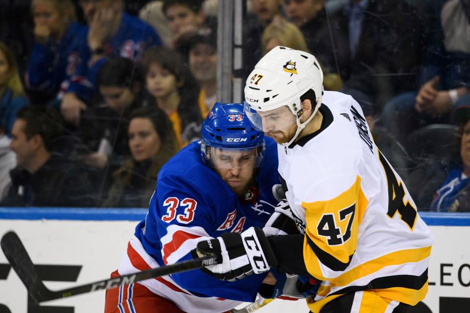 March 25, 2019: New York Rangers defenseman Fredrik Claesson (33) battles Pittsburgh Penguins center Adam Johnson (47) during the game between The New York Rangers and The Pittsburgh Penguins at Madison Square Garden in Manhattan, New York. The Pittsburgh Penguins defeat The New York Rangers 5-2. Mandatory credit: Kostas Lymperopoulos/CSM (Credit Image: © Kostas Lymperopoulos/CSM via ZUMA Wire) (Cal Sport Media via AP Images)