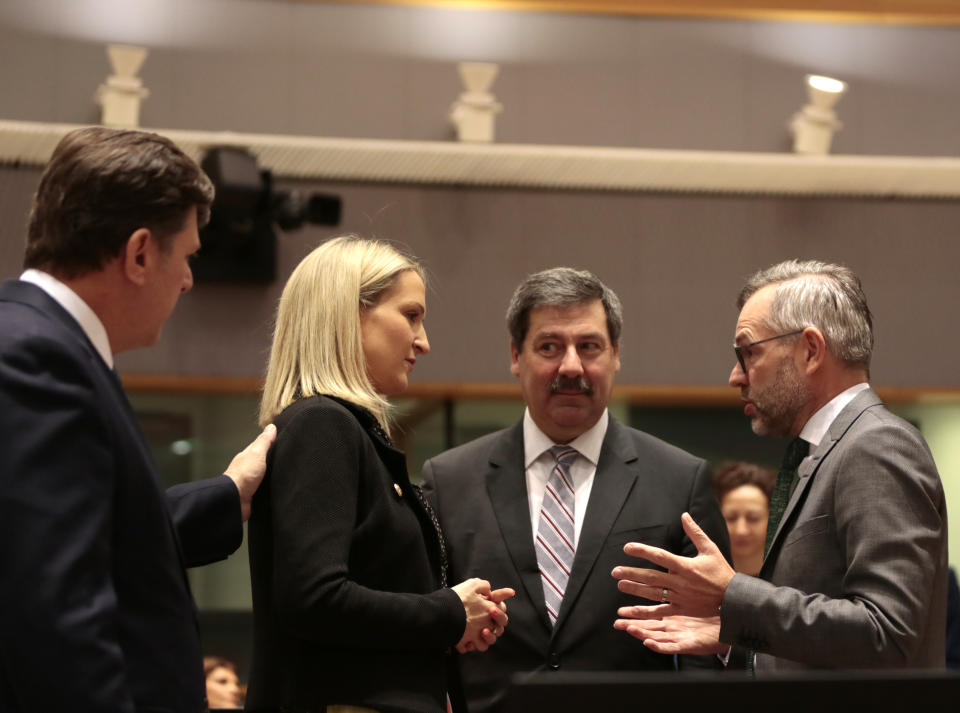 Irish Minister of State for European Affairs Helen McEntee, second left, speaks with Slovakia's State Secretary of the Foreign Ministry Frantisek Ruzicka, second right, and German Minister of State for European Affairs Michael Roth, right, during a meeting of EU General Affairs ministers at the European Council building in Brussels, Tuesday, Feb. 25, 2020. European Union ministers are putting the final touches on the mandate that will be the guide for EU negotiator Michel Barnier as he sits own with UK officials to thrash out a free trade deal over the next ten months. (AP Photo/Virginia Mayo)