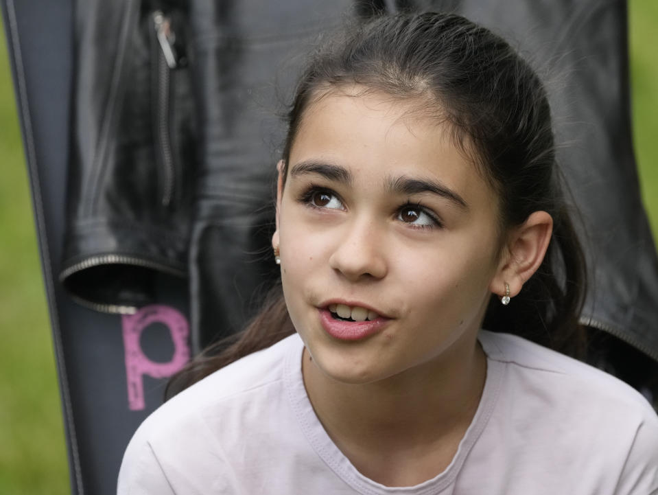 Milana Minenko, a 9-year-old child from Ukraine, glances to the side during an interview with The Associated Press, in Warsaw, Poland, Wednesday June 7, 2023. Russian forces have destroyed 262 educational institutions and damaged another 3,019 in their invasion of Ukraine, according to government figures. For those who've fled to other countries, schooling is suffering in unprecedented ways, according to families, educators, experts and advocates. The effects of war and relocation combined with the challenges of studying in a new country are compounding educational setbacks for young refugees. (AP Photo/Czarek Sokolowski)